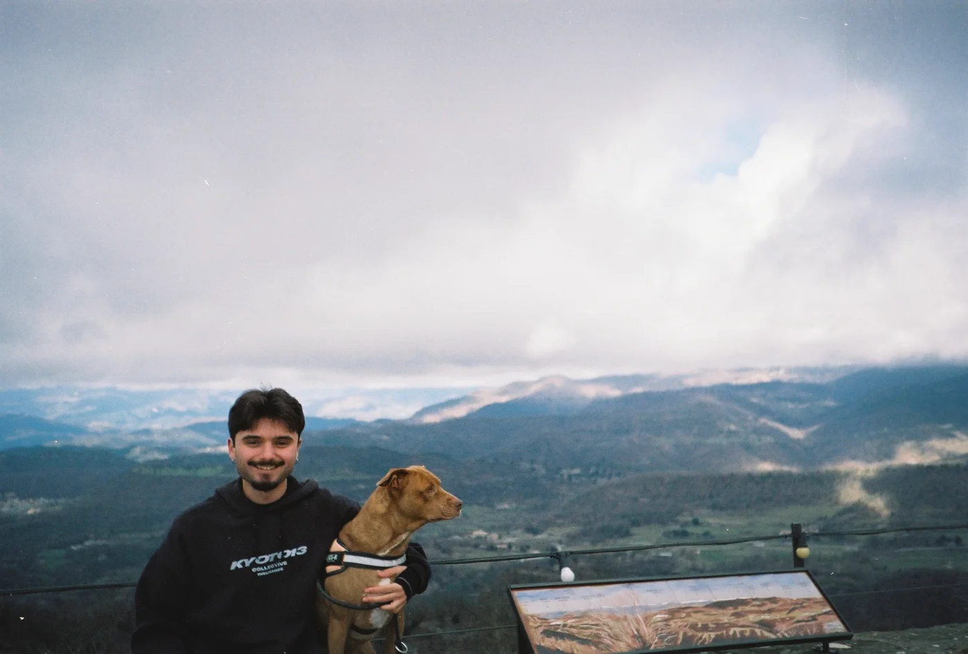Eric with his dog on a mountain overlook